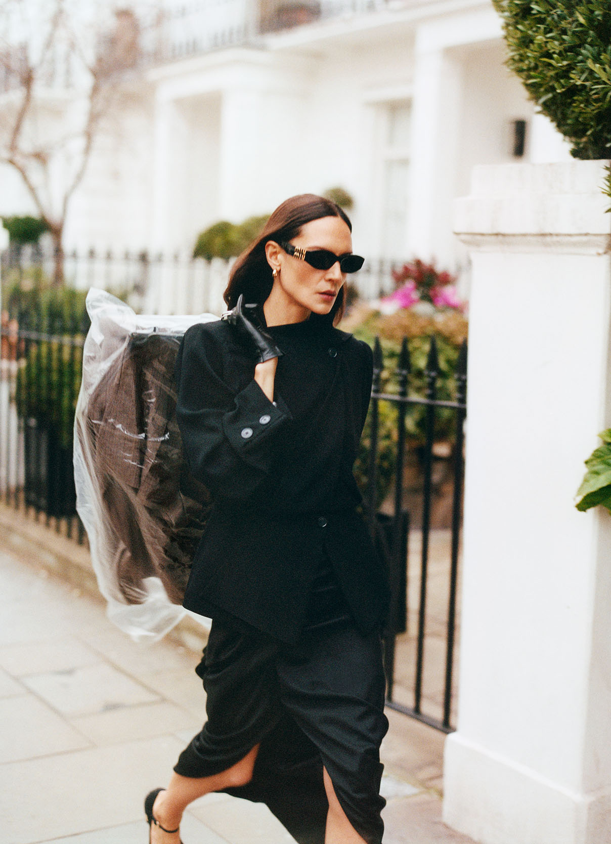 Woman walking down the street in drapey black skirt and a casual shirt