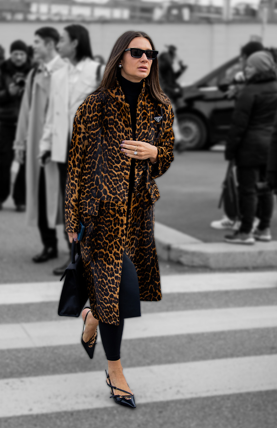 Woman in leopard print coat and black Miu Miu kitten heels