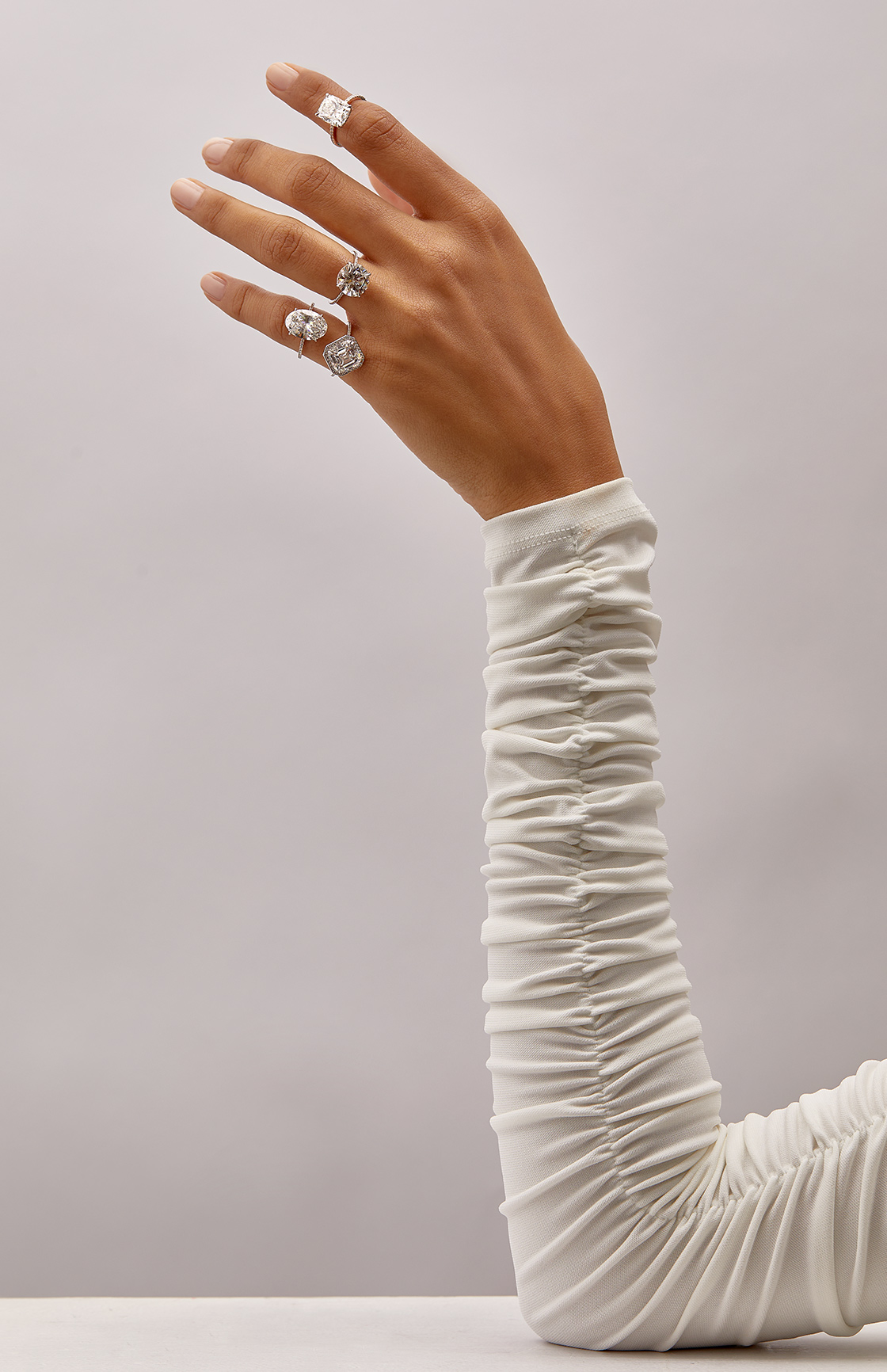 Models hand wearing stacked rings