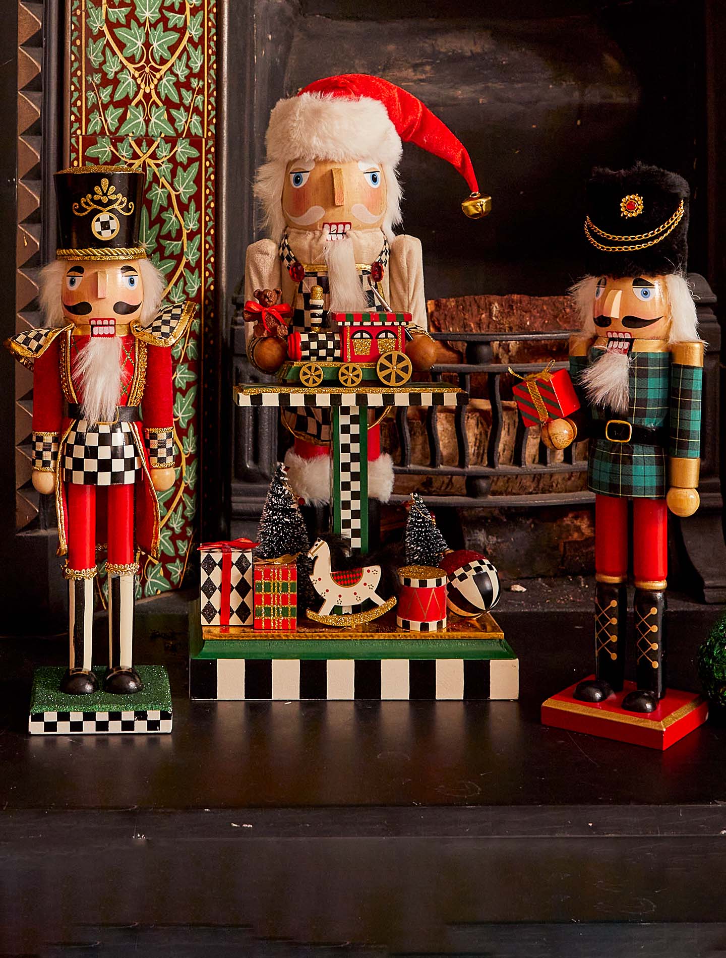 A row of Christmas Nutcrackers in front of the festively decorated fireplace