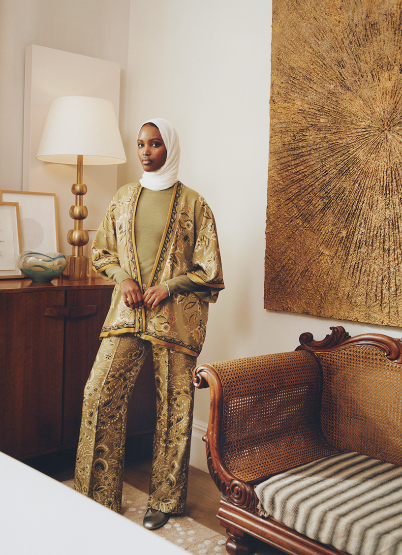 Woman wearing green two piece set and a white headscarf