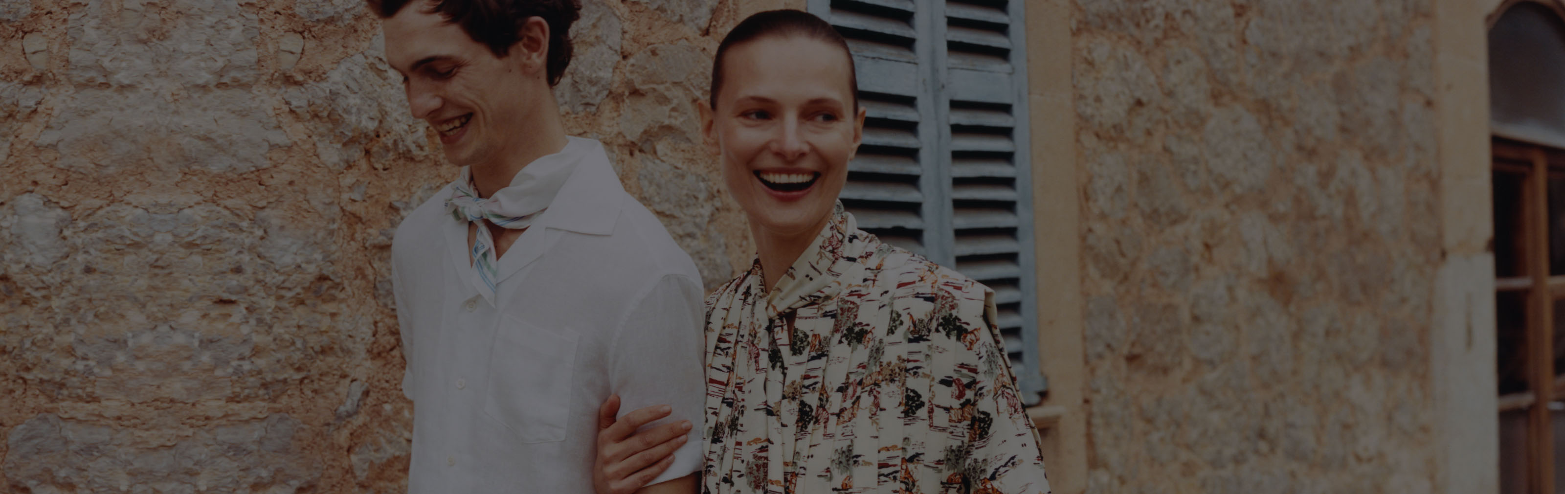 A young man, woman walking and smiling