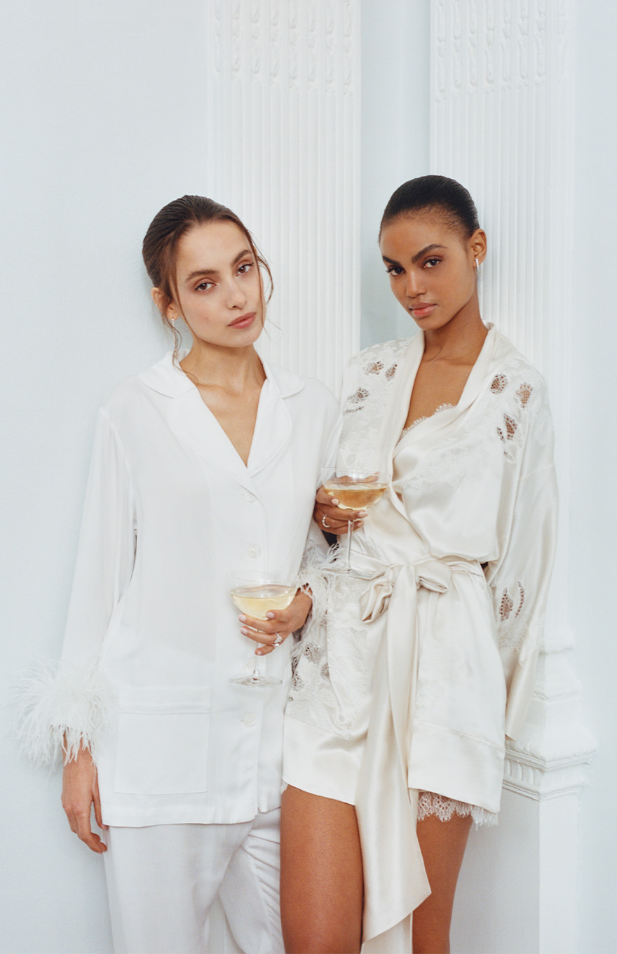 Two women wearing white sleepwear and loungewear