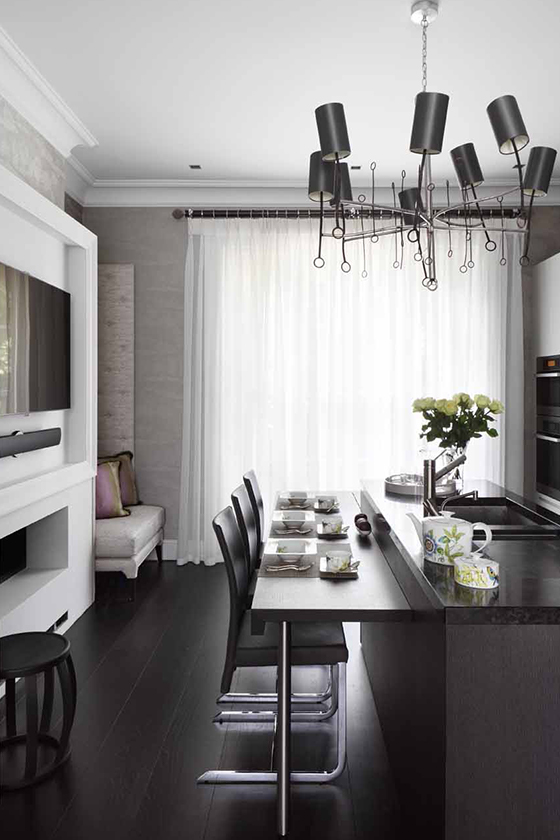 Kitchen and dining room area with breakfast bar and television over the fireplace