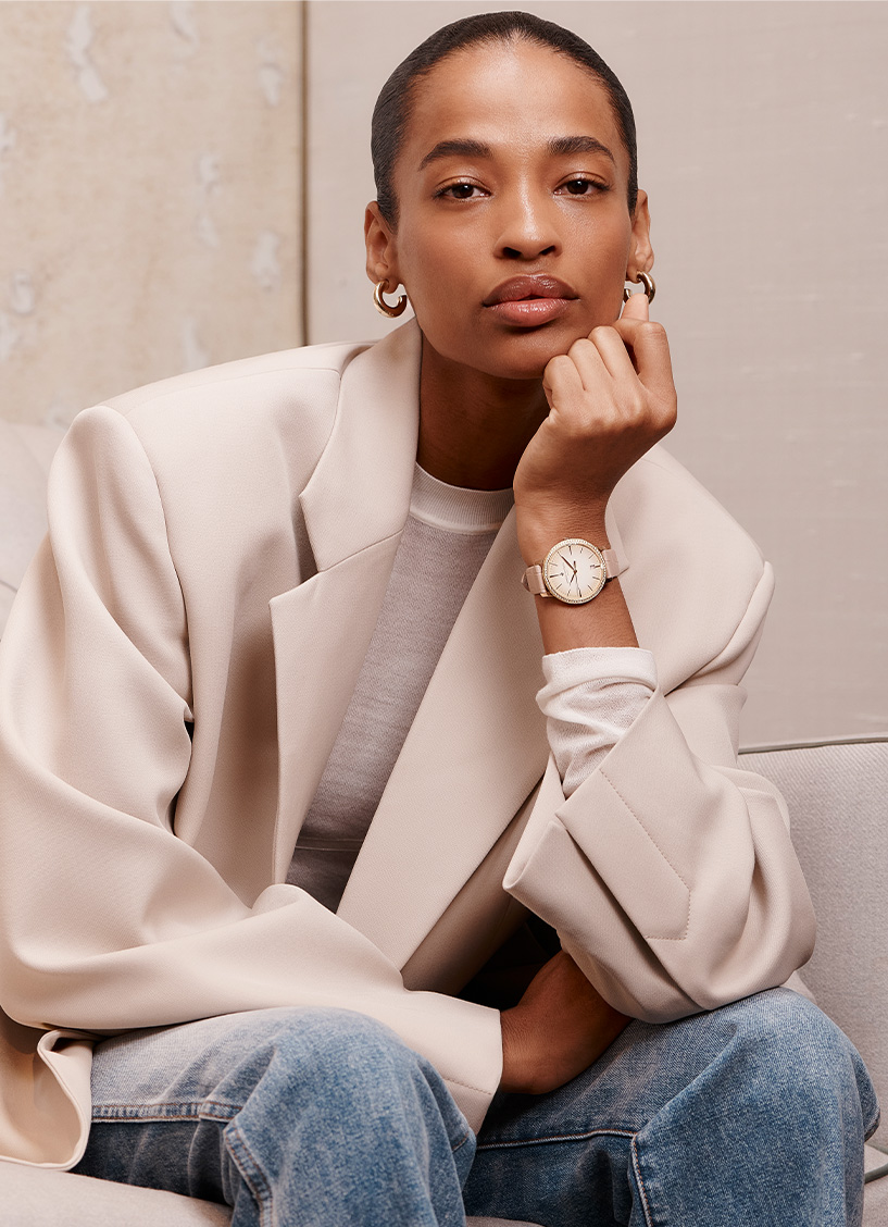 Model wears a blush coloured suit and a Vacheron watch