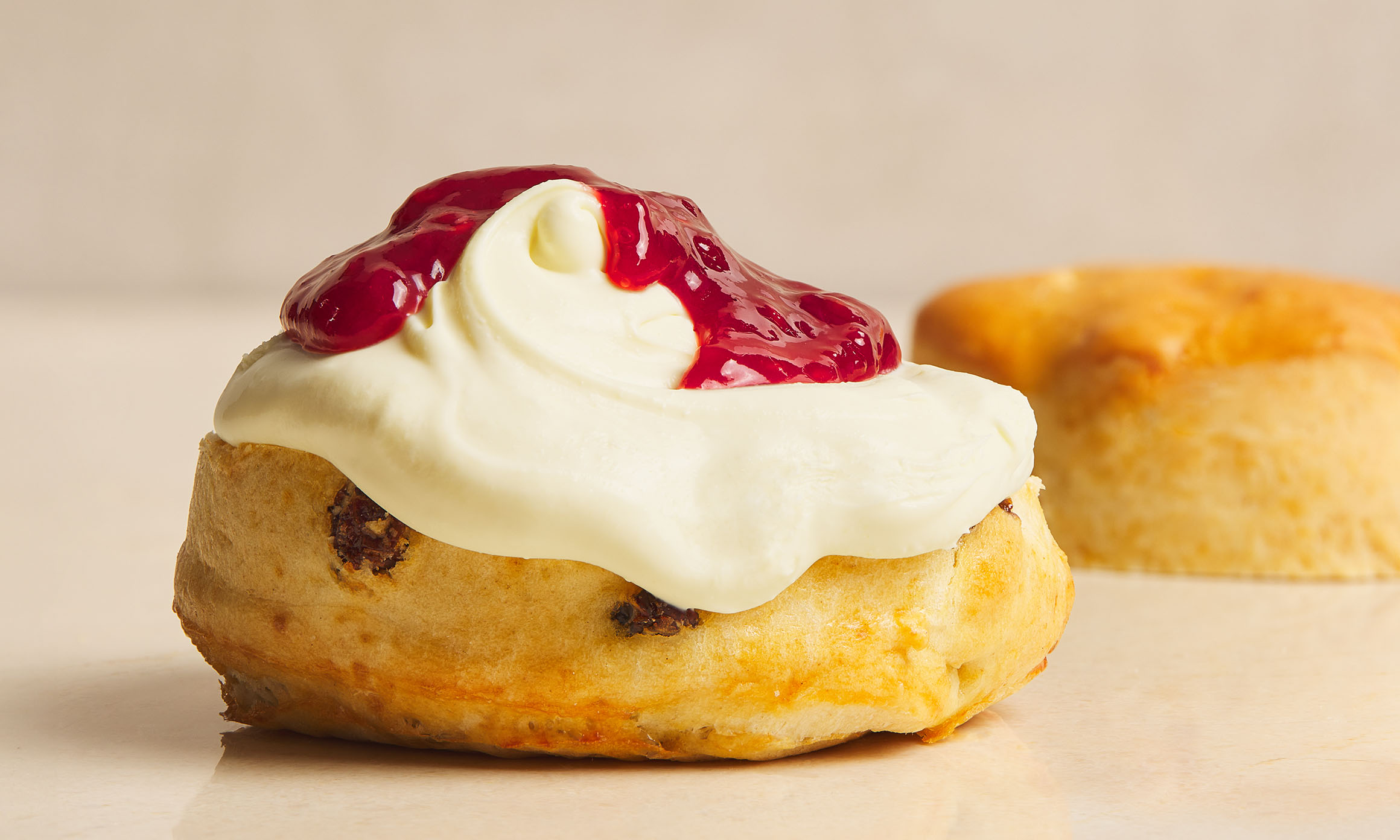 Scone layered with jam and clotted cream