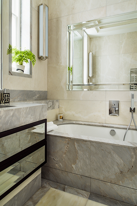 Grey marble bathroom with large glass mirror