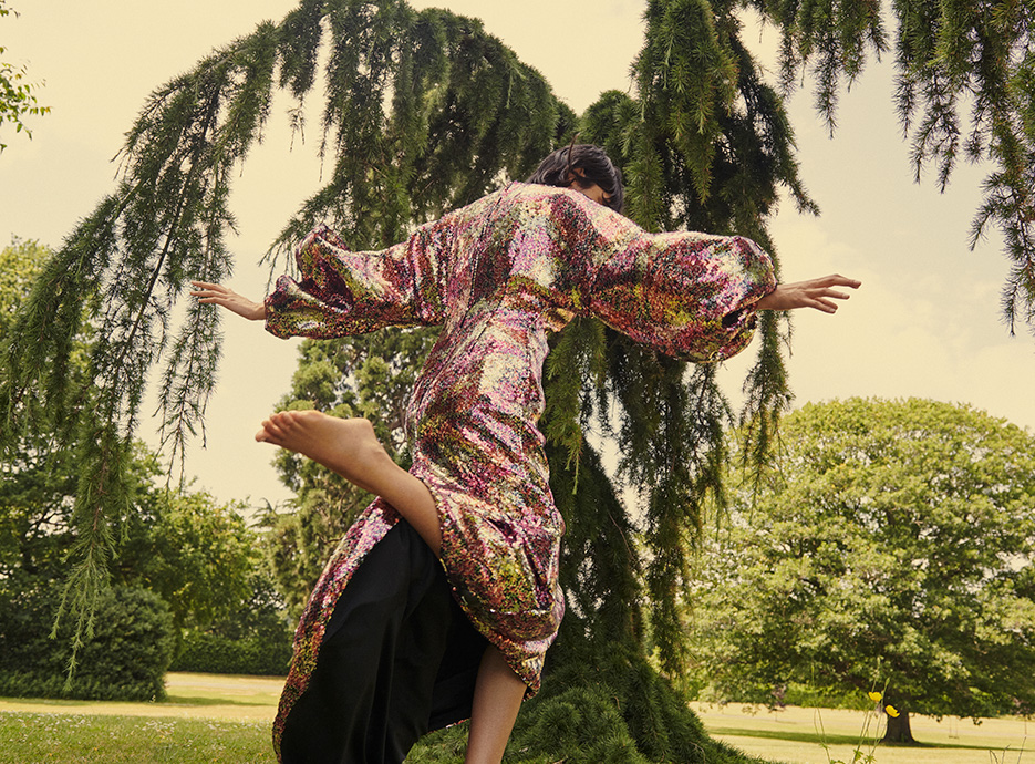 Ameera in a multi-colour Halpern sequin dress leaping