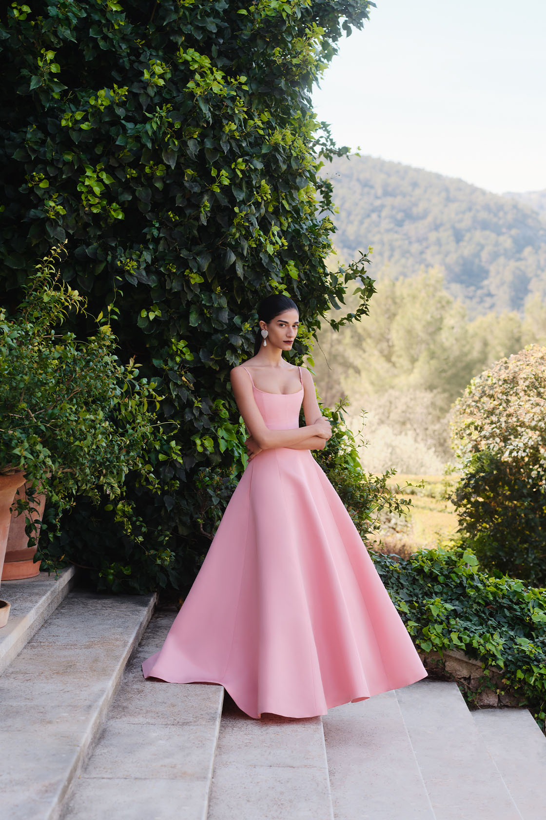 Woman in Carolina Herrera dress and Alessandra Rich earrings