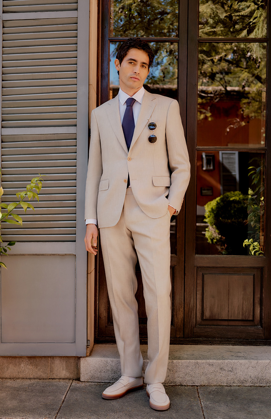 Man in beige linen suit in sunny location