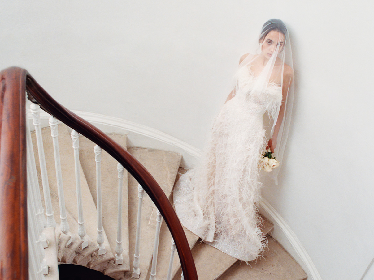 Two women in ivory wedding dresses walking away from the camera