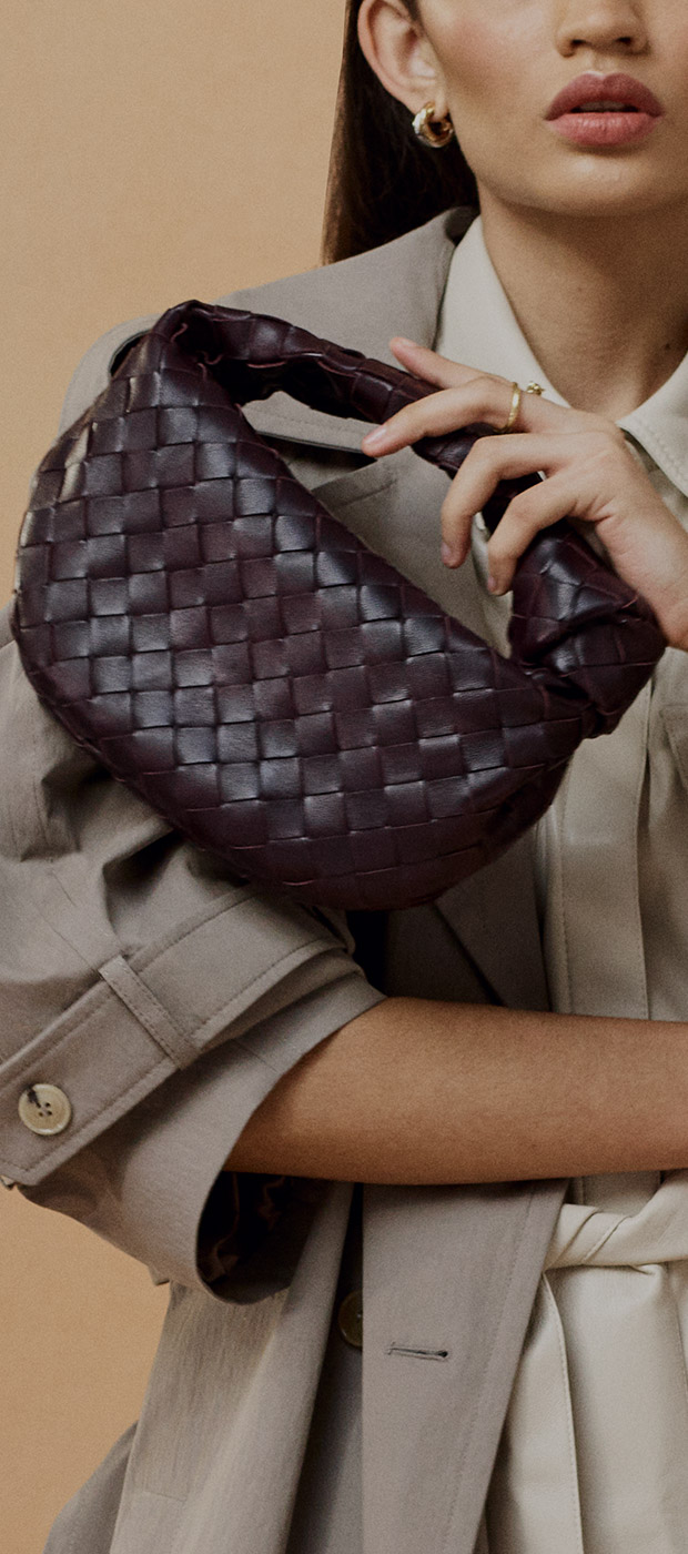 Woman holding a brown leather bag