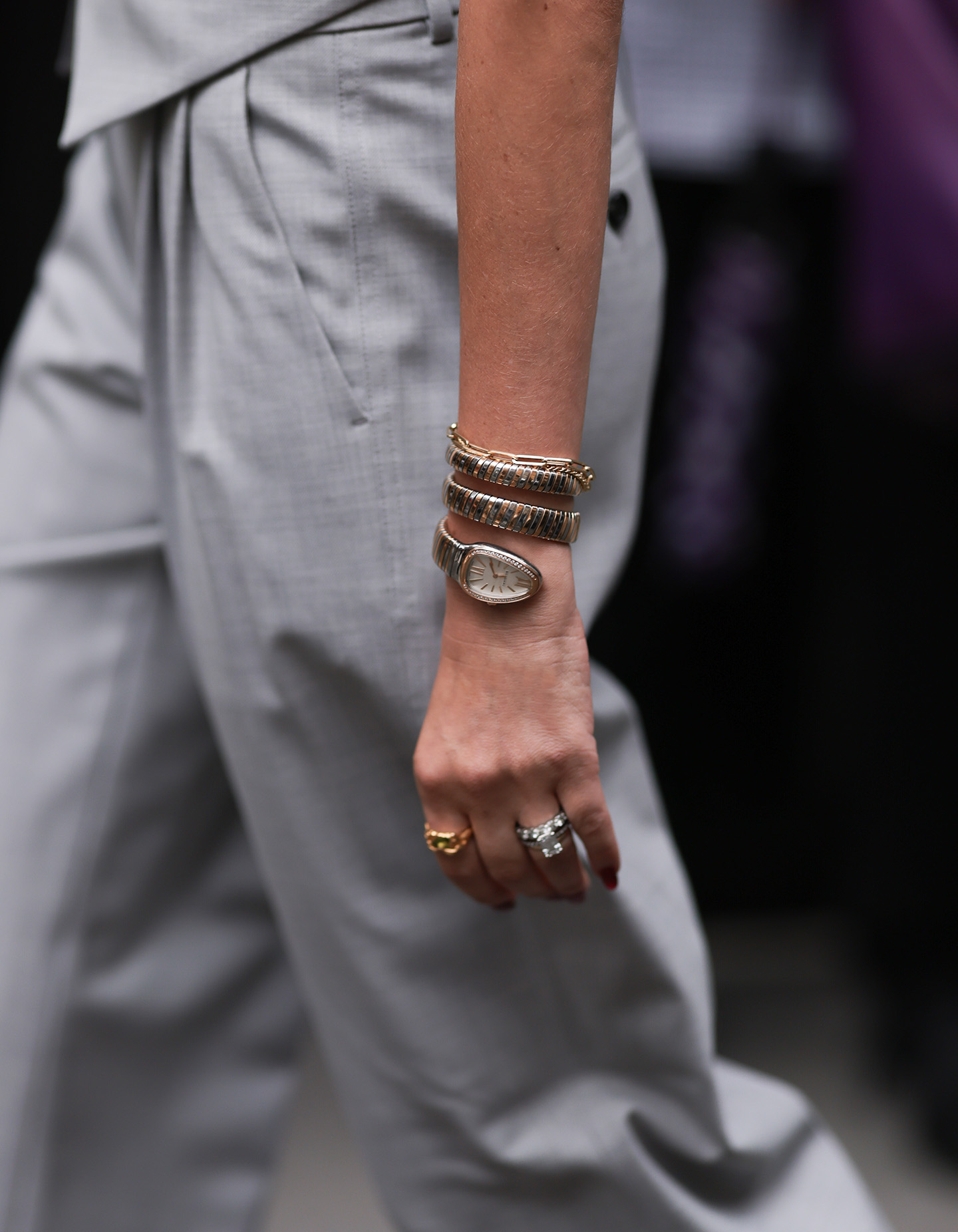 Woman wearing grey suit with a silver Bulgari Serpenti Tubogas watch