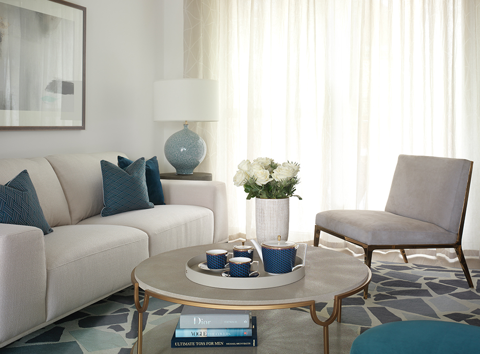 Living room setting with sofa, chair and large marble coffee table