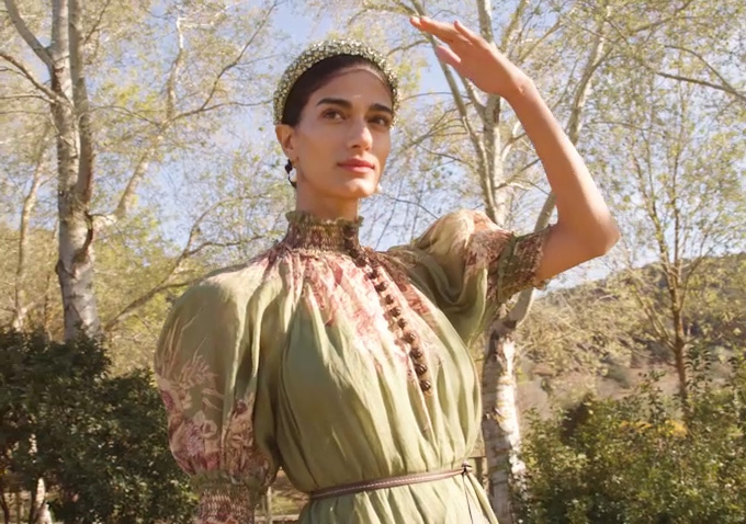 Model wears green floral Zimmermann dress and embellished Jennifer Behr headband