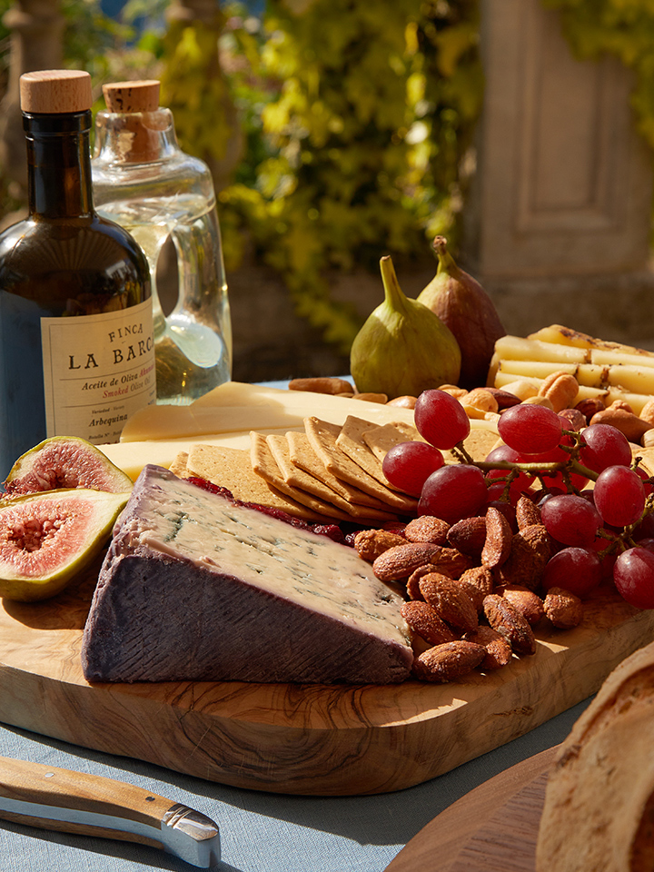 Plate with cheese, nuts, grapes and figs