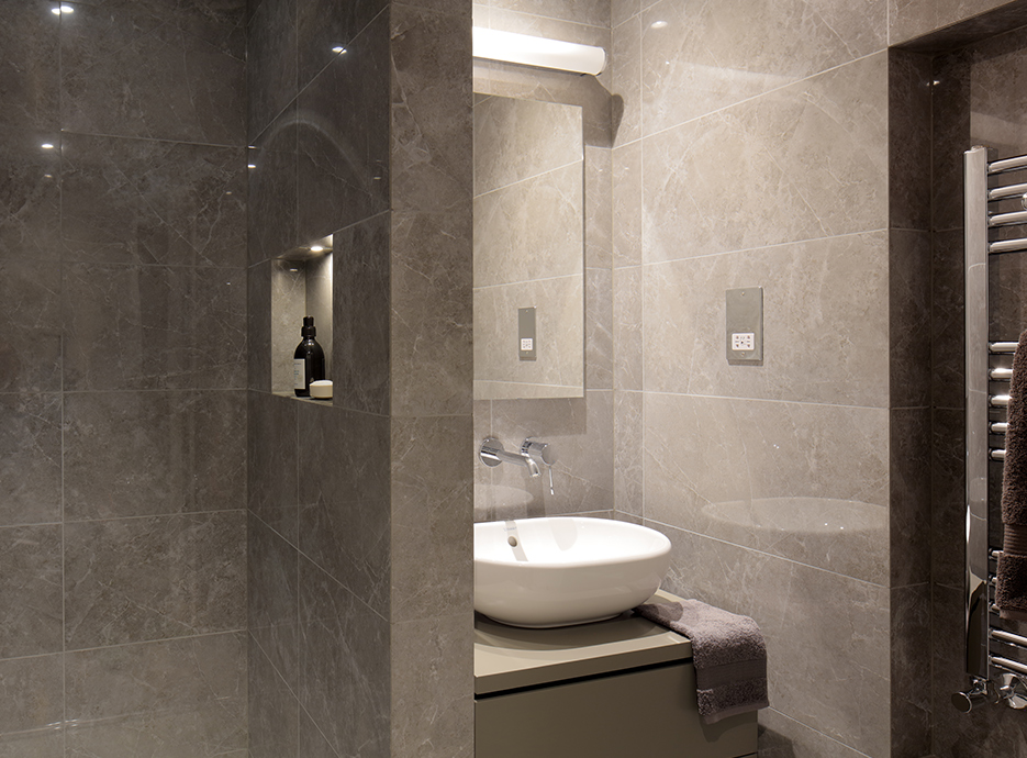 Grey marble bathroom with sink and walk-in shower