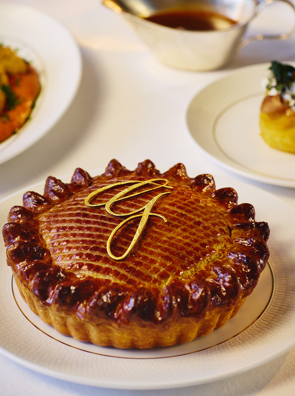 A golden brown crusted pie decorated with a 'G' from The Georgian