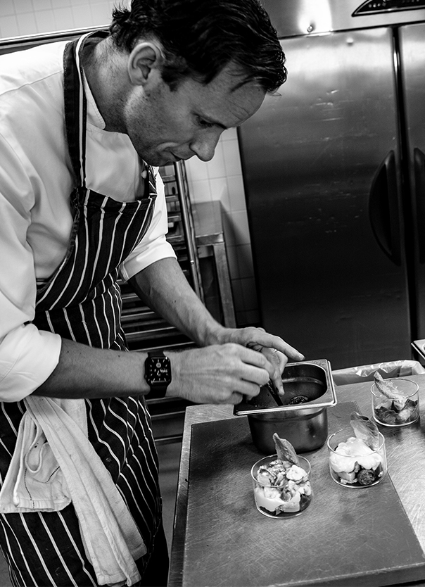 Chef creating the prawn cocktail dish in one of our kitchens