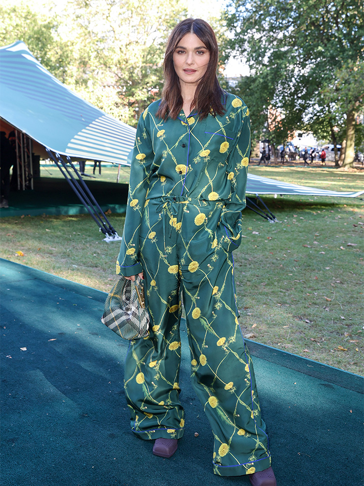 Wearing a printed green shirt and matching trousers, actress Rachel Weisz attends the Burberry Spring/Summer 2024 runway at London Fashion Week