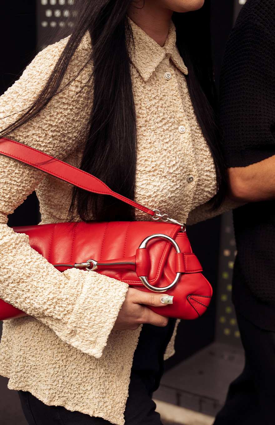 Woman holding red Gucci bag