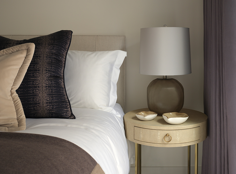 Side table in guest bedroom with grey and green muted tones