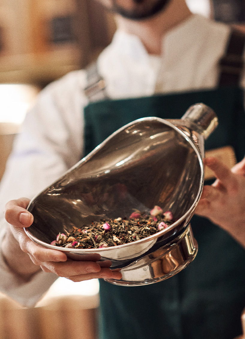 Our in-store expert staff showing a pink rose bud tea