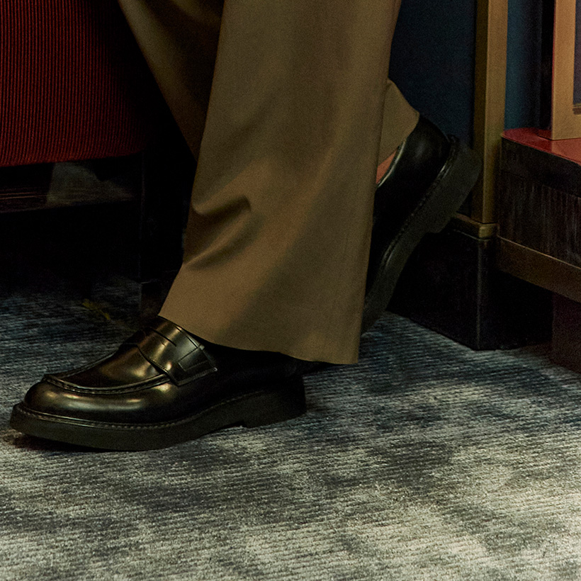 Brown leather loafers matched with an olive green suit