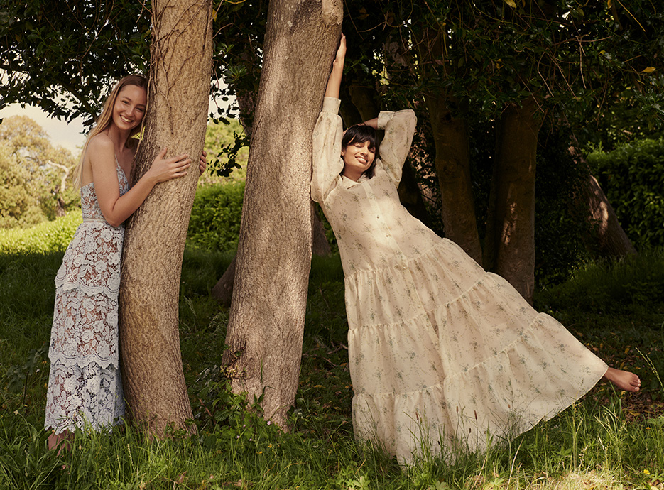 Rose and Ameera in floral, lacy Self-Portrait and Brock Collection summer dresses by a tree