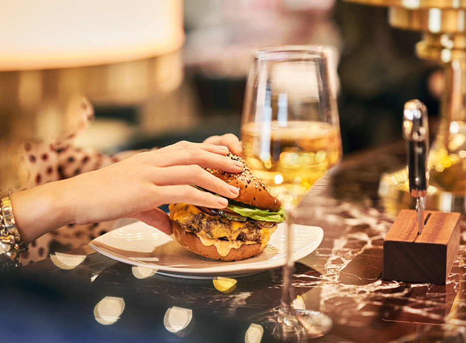 Woman picking up the American Burger