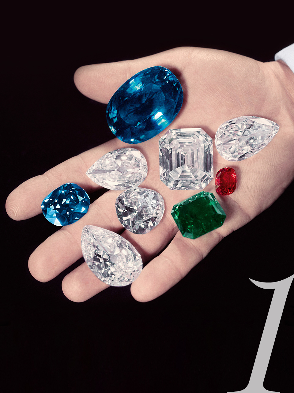 Harry Winston holding jewels in hand