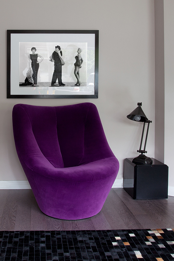 Bright purple chair with a black and white photo above