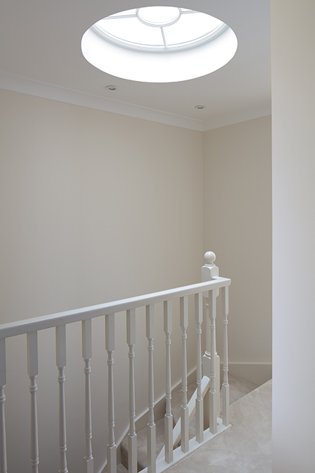 Top of staircase with circular window in the ceiling