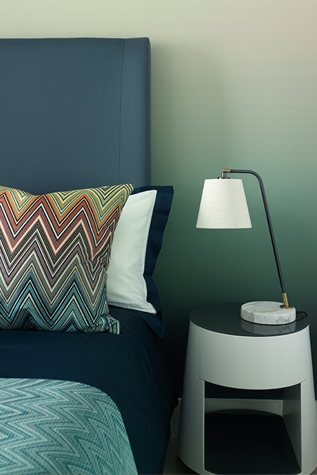 Bed side table of bedroom in green and blue tones