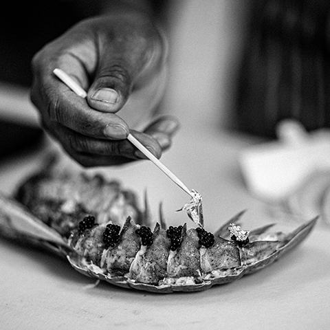 Chef delicately dressed the lobster with gold leaf