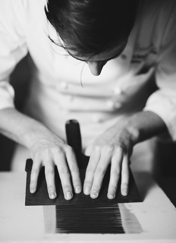 Chef chocolatier spreading out chocolate