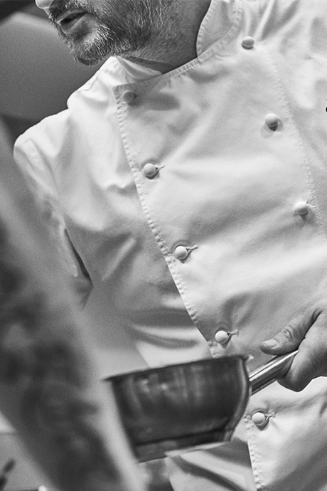 Close-up of Jason Atherton holding a saucepan in the kitchen